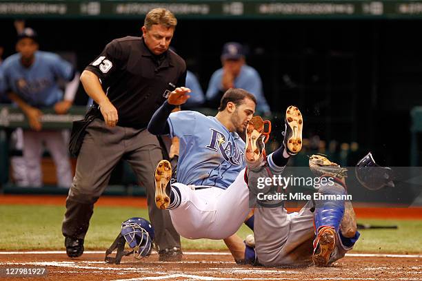 Sean Rodriguez of the Tampa Bay Rays crashes into Mike Napoli of the Texas Rangers to score on a play at the plate on a double by Matt Joyce in the...