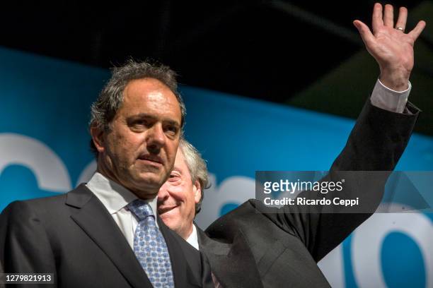 Former President Nestor Kirchner waves to supporters behind Buenos Aires Province Governor, Daniel Scioli during elections rally for Deputy on...