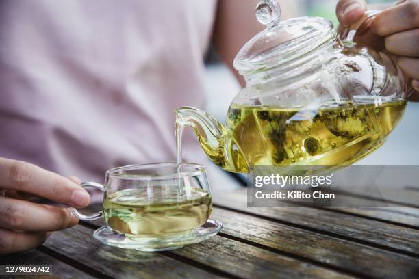 asian woman enjoy a cup of herbal tea - green tea stock pictures, royalty-free photos & images