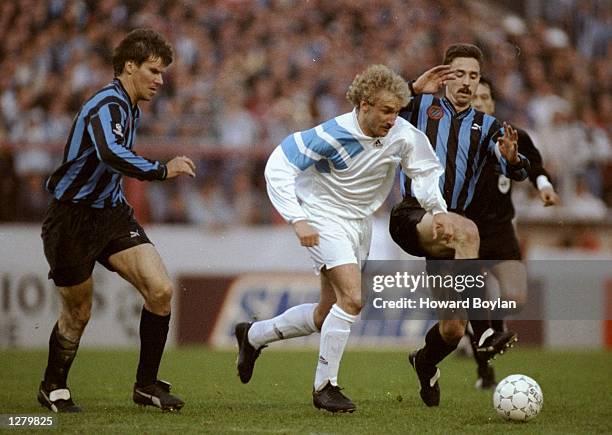 Rudi Voeller of Marseille gets away from Lorenzo Staelens of Club Brugge KV during a Champions League match at the Olympic Stadium in Bruges,...