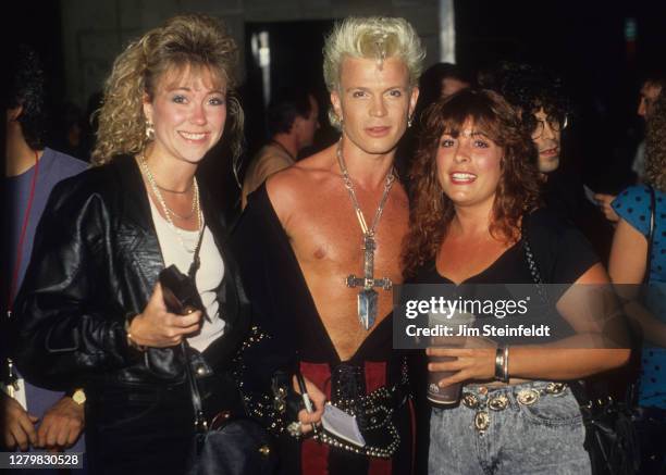 Rock singer Billy Idol and fans pose for a portrait at the Minneapolis Auditorium in Minneapolis, Minnesota on April 28, 1987.