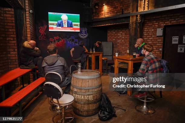 People, in the Rubber Soul Beatles Bar in Mathew Street, in the heart of the city's nightlife, watch British Prime Minister Boris Johnson announce...