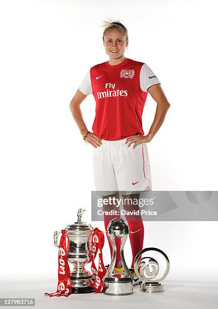 Steph Houghton of Arsenal Ladies FC with the trophies won this season during a Photo Shoot at London Colney on October 04, 2011 in St Albans, England.