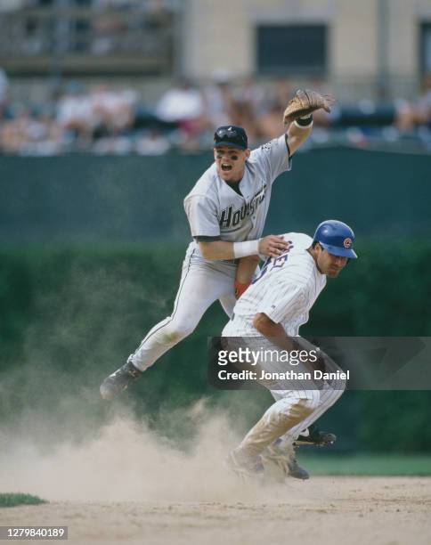 Craig Biggio, Second Baseman for the Houston Astros runs out Leo Gomez of the Chicago Cubs at second base during the Major League Baseball National...
