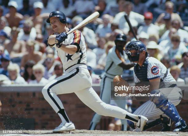 Glenn Davis, First Baseman for the Houston Astros swings the bat as Jody Davis, catcher for the Chicago Cubs looks on during their Major League...