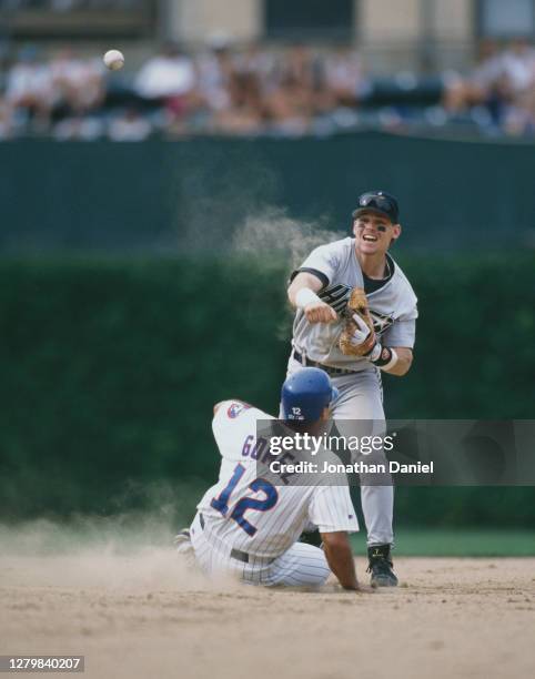 Craig Biggio, Second Baseman for the Houston Astros runs out Leo Gomez of the Chicago Cubs as he slides into second base during the Major League...