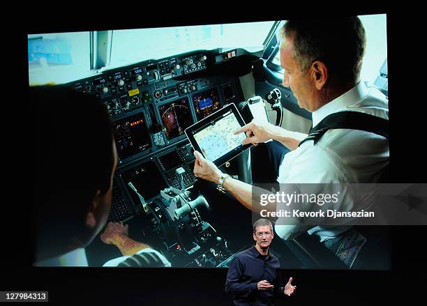 Apple CEO Tim Cook speaks in front of an image of iPad at the event introducing the new iPhone 4s at the company's headquarters October 4, 2011 in...