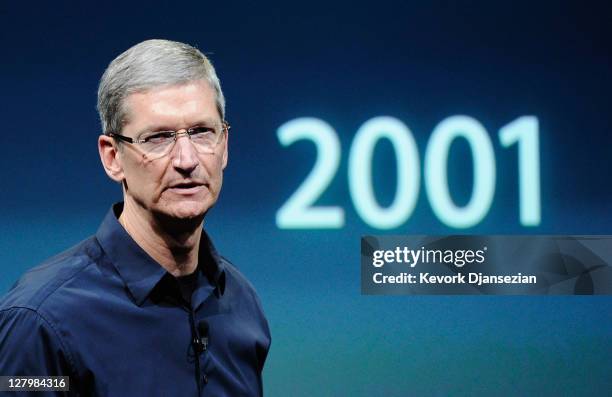 Apple CEO Tim Cook, standing in front of a screen showing the year the iPod was launched, speaks at the event introducing the new iPhone 4s at the...