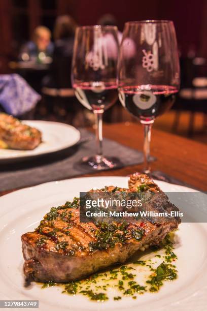 argentinian steak with red wine for dinner at a fine dining restaurant at a bodega, winery, in the maipu area of mendoza, mendoza province, argentina, south america - mendoza province stock-fotos und bilder