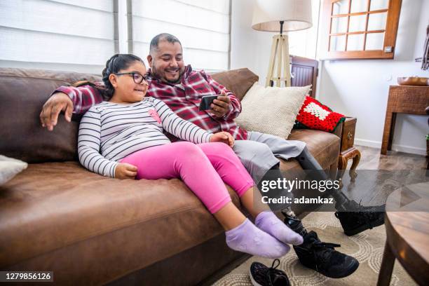 disabled father playing with daughter at home - amputee home stock pictures, royalty-free photos & images