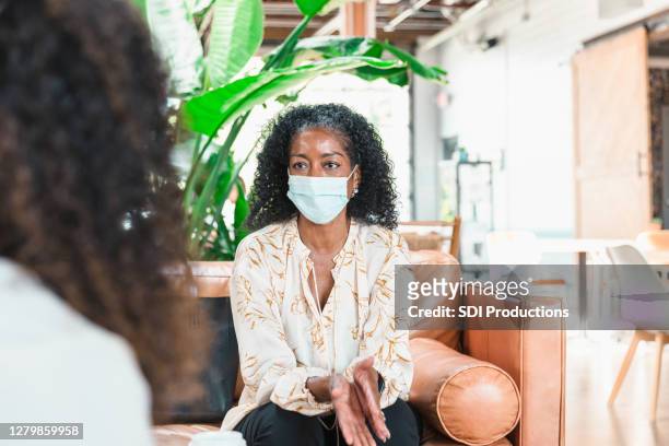 counselor gives advice to patient - employee engagement mask stock pictures, royalty-free photos & images