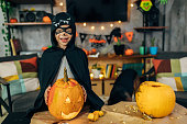 Adorable cute boy dressed as a bat costume his favourite super hero having fun during Halloween season