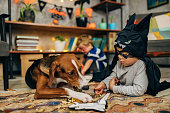 Little superhero and his dog spending fun time together during Halloween season
