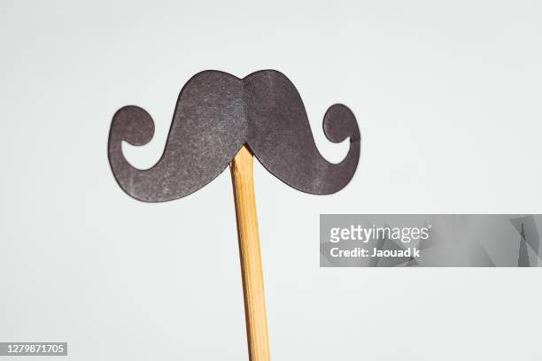 close up view of a a mustache photo booth props - movember stock-fotos und bilder