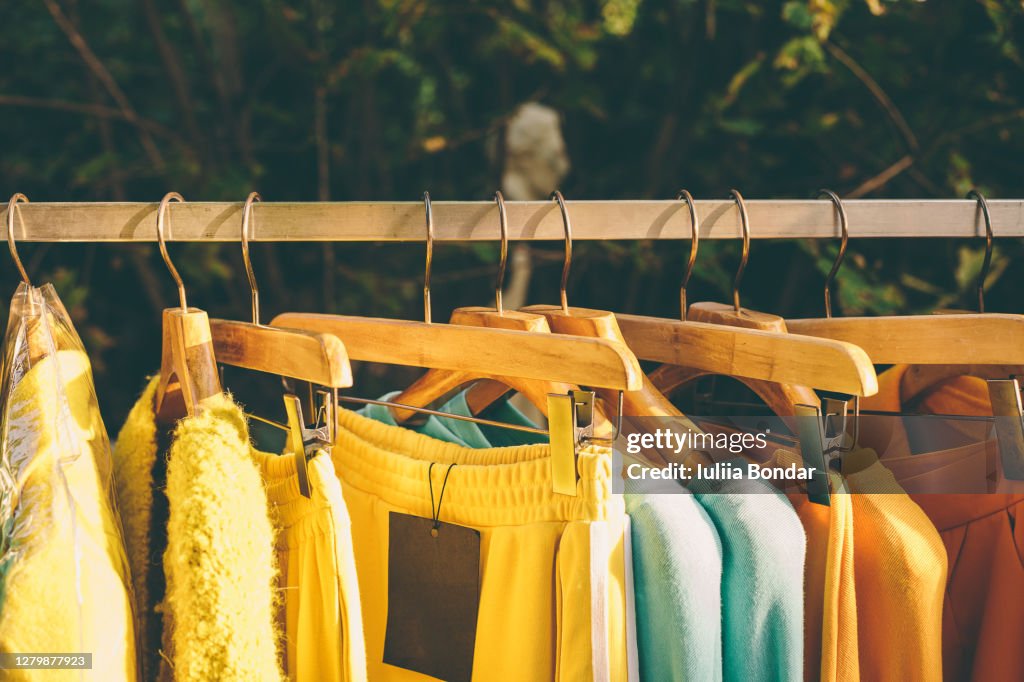 Clothes hang on a shelf in a designer clothes store