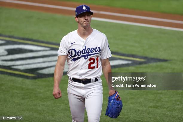 Walker Buehler of the Los Angeles Dodgers reacts as he walks to the dugout against the Atlanta Braves during the first inning in Game One of the...