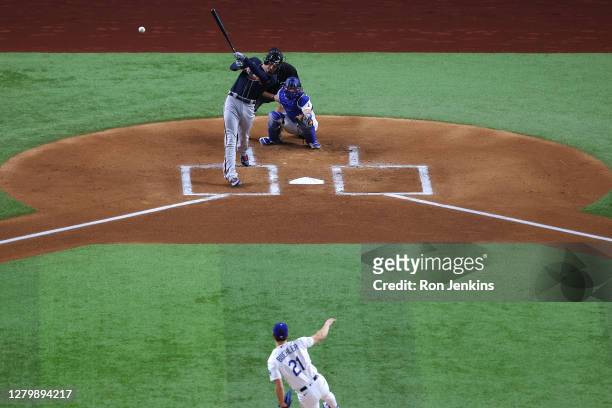 Freddie Freeman of the Atlanta Braves hits a solo home run against Walker Buehler of the Los Angeles Dodgers during the first inning in Game One of...