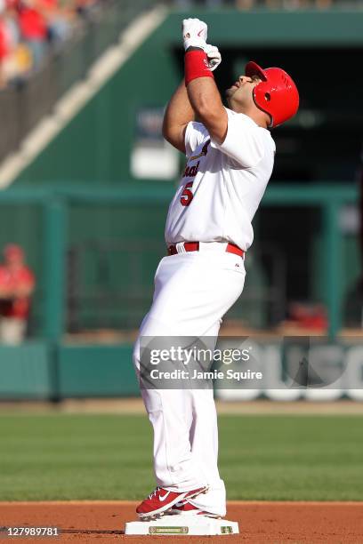Albert Pujols of the St. Louis Cardinals reacts after hitting a double against the Philadelphia Phillies in the first inning of Game Three of the...