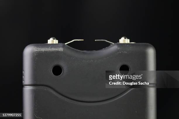 electroshock taser weapon on a black background - betäubungsgewehr stock-fotos und bilder