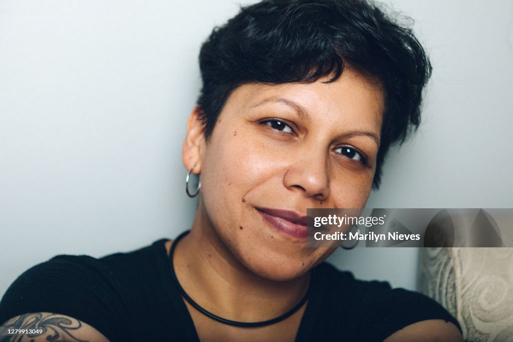 Androgynous latinx woman smiling
