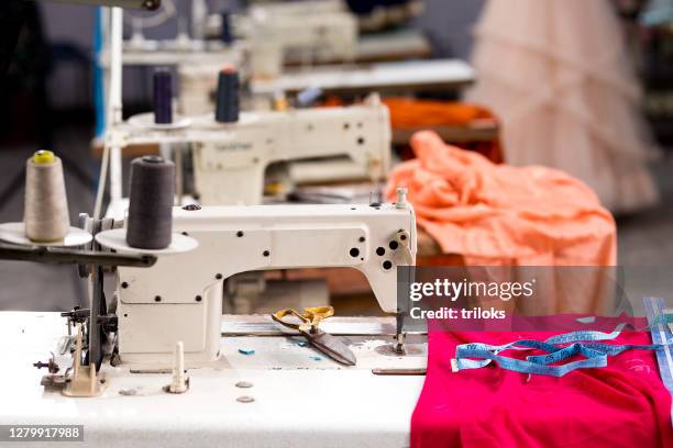 sewing or tailoring industrial hall with machinery - stitching imagens e fotografias de stock