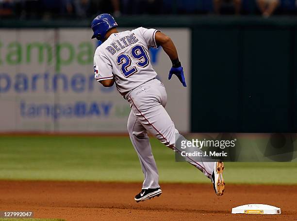 Infielder Adrian Beltre of the Texas Rangers rounds the bases after his third home run against the Tampa Bay Rays during Game Four of the American...