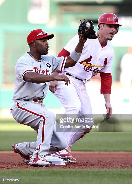 Ryan Theriot of the St. Louis Cardinals steals second base in the fourth inning as Jimmy Rollins of the Philadelphia Phillies tries for the tag...