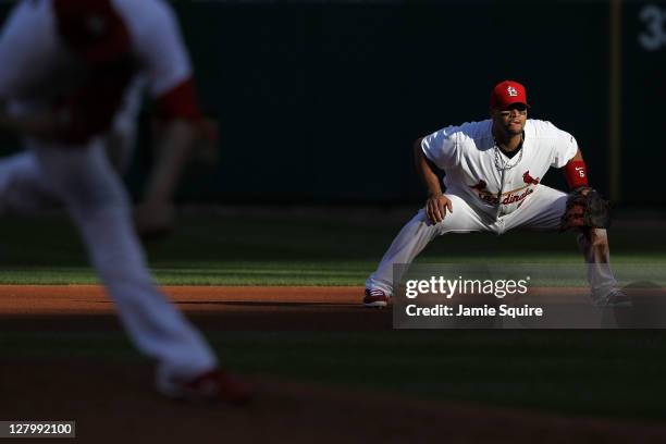 Albert Pujols of the St. Louis Cardinals stands on the field as Jaime Garcia throws a pitch during Game Three of the National League Division Series...