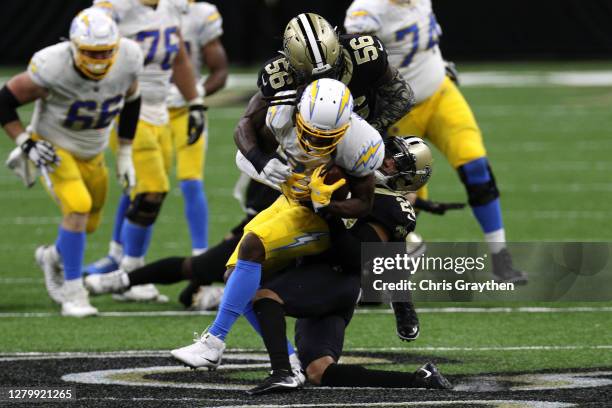 Mike Williams of the Los Angeles Chargers is tackled short of the line to gain on fourth down by Marshon Lattimore of the New Orleans Saints during...