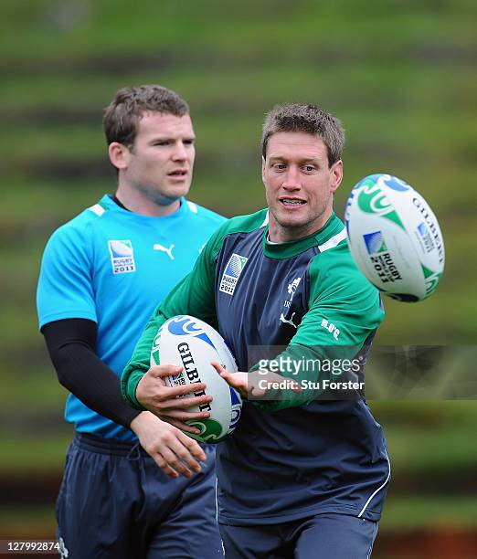 Ronan O'Gara of Ireland eyes the ball as Gordon D'Arcy looks on during an Ireland IRB Rugby World Cup 2011 training session at Rugby League Park on...