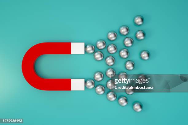 magnet and chrome balls - loyalty concept stock pictures, royalty-free photos & images