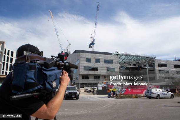 The media film the location of a collapsed building on October 13, 2020 in Perth, Australia. After falling 20 meters, one person has died and another...