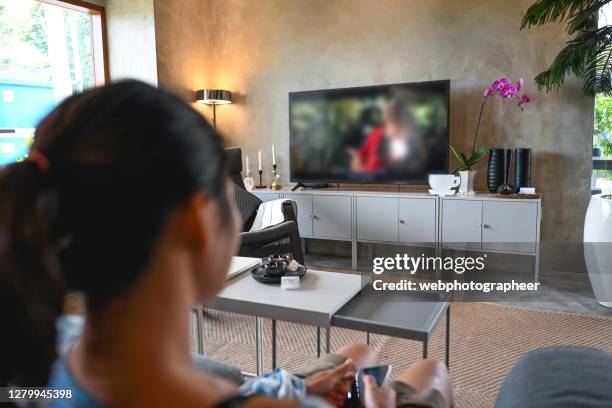 watching television - legs on the table stock pictures, royalty-free photos & images