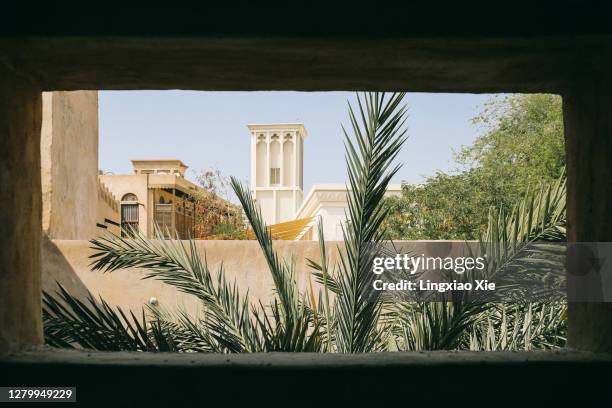 cityscape of al fahidi historical district (or al bastakiya) seen from window, old dubai, united arab emirates - the palm dubai stock-fotos und bilder