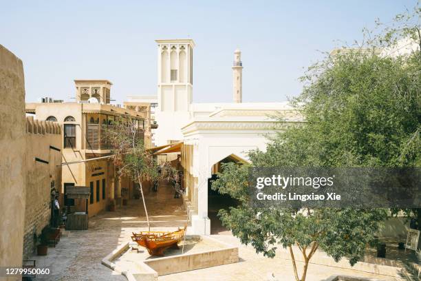 al fahidi historical district in old dubai with the grand mosque at back, united arab emirates - al bastakiya quarter stock pictures, royalty-free photos & images