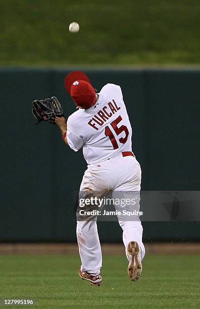 Rafael Furcal of the St. Louis Cardinals makes an over-the-shoulder catch in the ninth inning of Game Three of the National League Division Series...