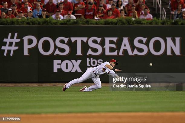 Skip Schumaker of the St. Louis Cardinals makes a diving catch in the on a fly ball by Carlos Ruiz of the Philadelphia Phillies in the ninth inning...