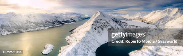 winter sunset over snowy mountains and fjord, finnmark, norway - alta stock-fotos und bilder