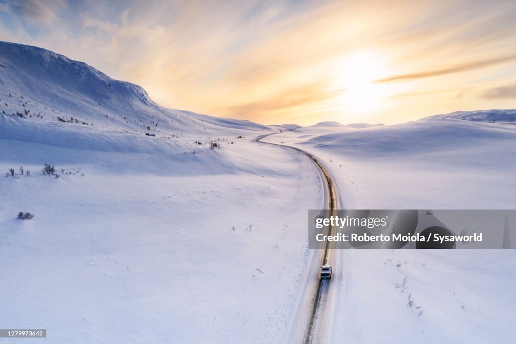 Pick-up truck traveling on snowy road, Sennalandet, Finnmark, Norway