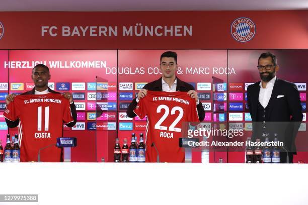 Newly signed FC Bayern Muenchen players Douglas Costa and Marc Roca pose next to Hasan Hasan Salihamidžić, sporting director of FC Bayern Muenchen...