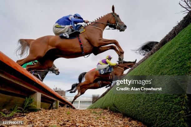 Sam Twiston-Davies riding Guy clear the open ditch on their way to winning The MansionBet Proud To Support British Racing Novices' Handicap Chase at...