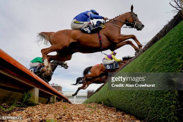 Sam Twiston-Davies riding Guy clear the open ditch on their way to winning The MansionBet Proud To Support British Racing Novices' Handicap Chase at...