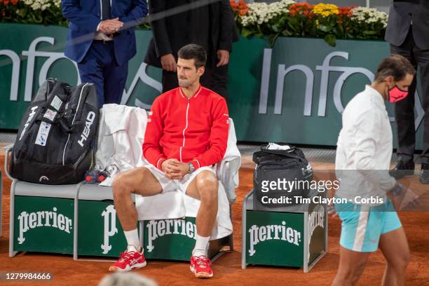 October 11. Novak Djokovic of Serbia reflects on his loss against Rafael Nadal of Spain who heads back to his seat after an on court interview after...
