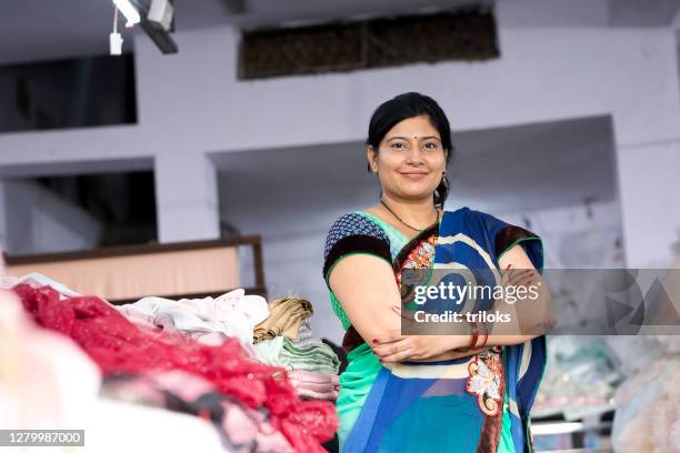 woman textile worker checking garment stock at factory - fashion industry stock pictures, royalty-free photos & images