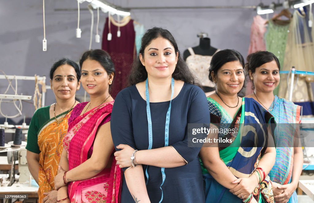 Female textile workers standing together in solidarity at factory