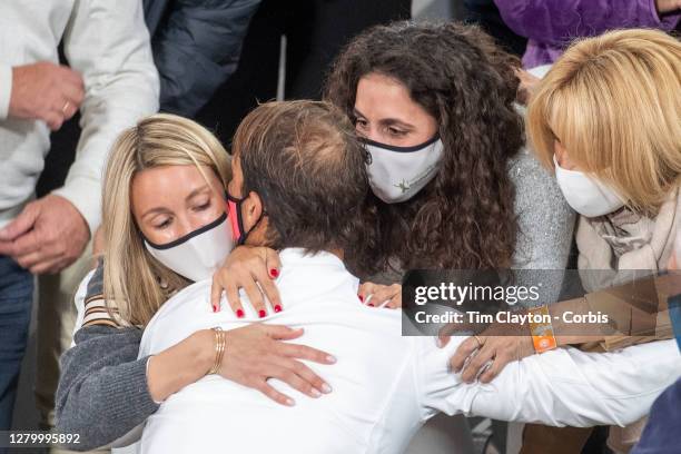 October 11. Rafael Nadal of Spain is congratulated by his sister Maria Isabel Nadal, his wife Xisca Perello, his mother Ana Maria Parera after his...