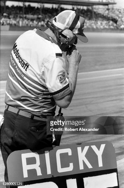 Crew chief and car owner Bud Moore communicates with his racecar driver, Ricky Rudd, during the running of the 1985 Daytona 500 stock car race at...