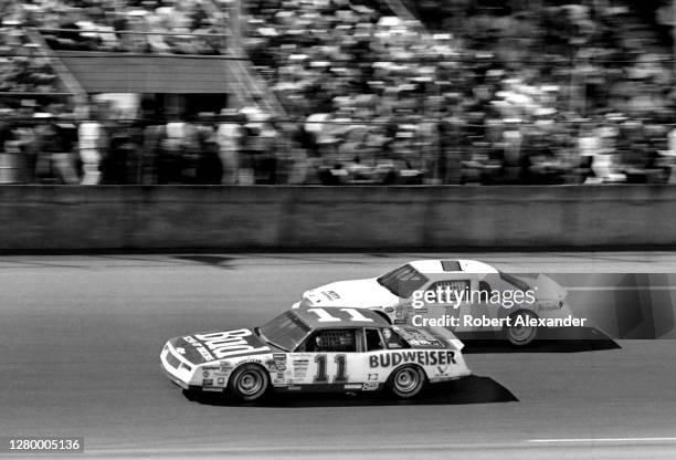 Driver Darrell Waltrip battles with driver Dick Brooks during the running of the 1985 Daytona 500 stock car race at Daytona International Speedway in...