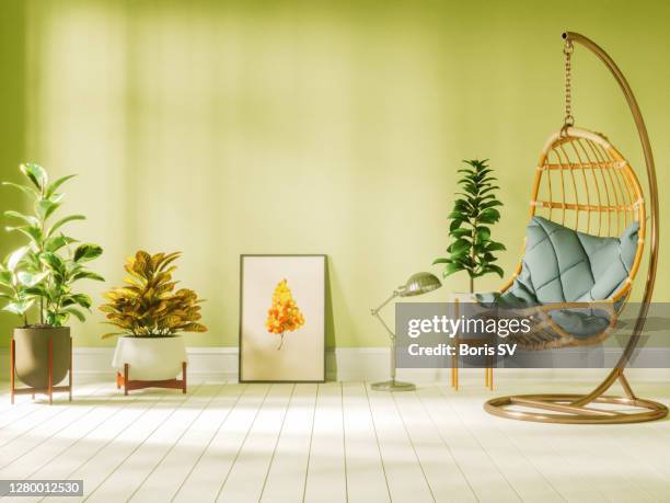 living room with hanging egg chair and plants - bubble chair stock-fotos und bilder