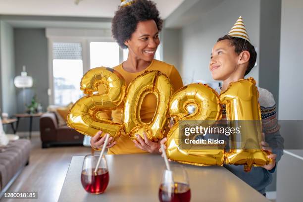 mother and son celebrating ney year 2021 at home - 2021 stock pictures, royalty-free photos & images